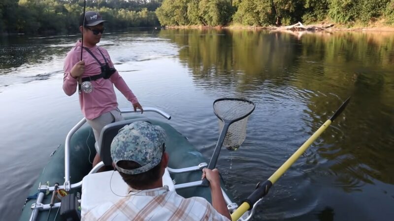 two men in a boat fishing