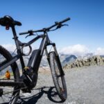 E-bike on a mountain trail with clear sky and peaks in the background
