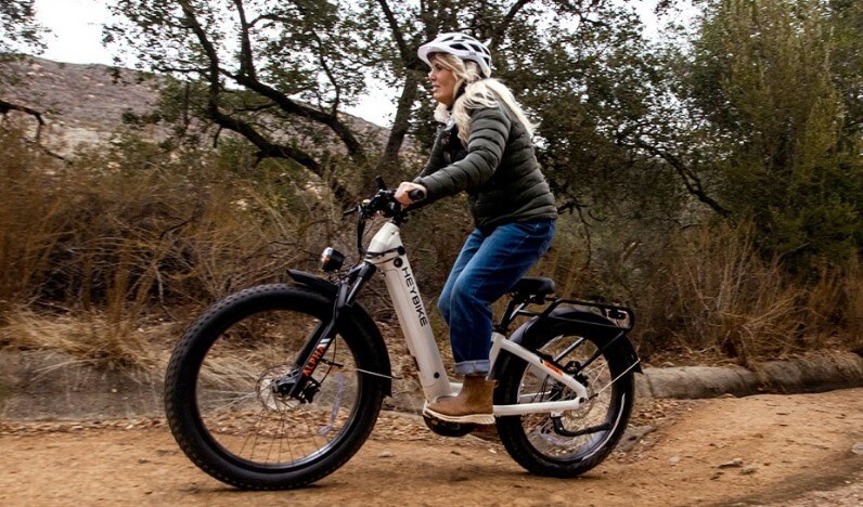 Woman on an electric bike navigates a rugged trail
