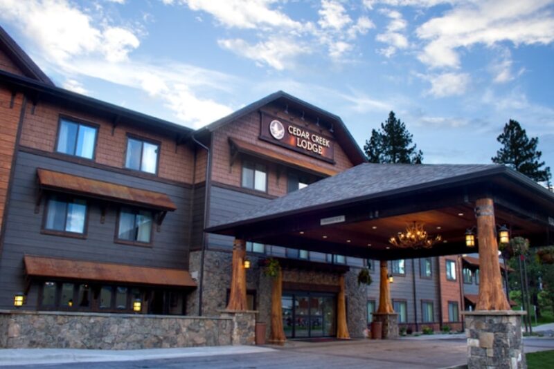 Timber-style hotel lodge near Glacier Park with stone base and covered entrance