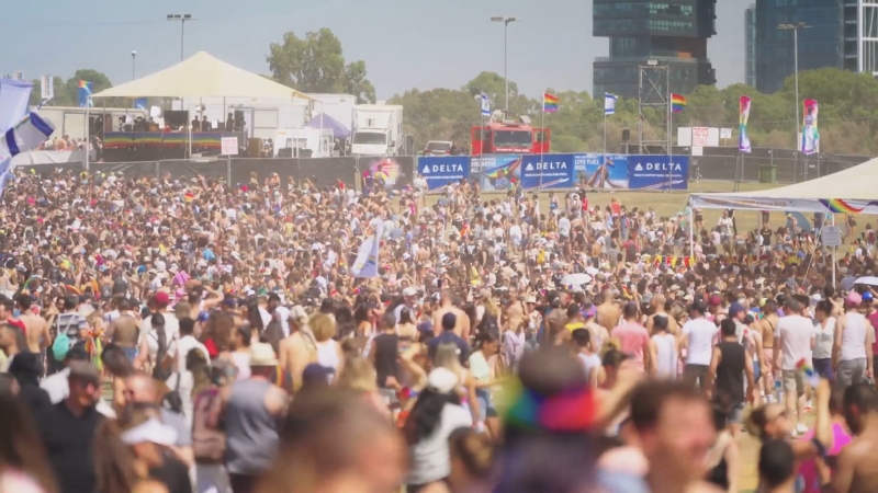 A massive crowd fills the festival grounds under the sun at Lollapalooza 2025