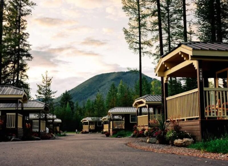 Cluster of tiny homes surrounded by forest and mountain views