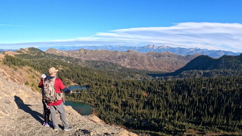 Hikers looking out over forests, lakes, and mountains in the Jewel Basin Hiking Area of Flathead National Forest