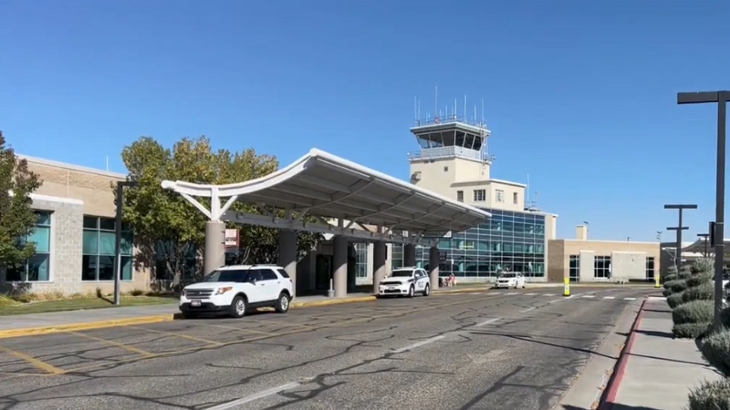 Idaho Falls Regional Airport shown with cars at the curb and the control tower visible