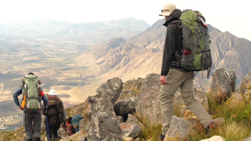 Backpackers on a high mountain trail during a backpacking trip for a large group