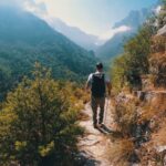 Hiker walking along a mountain path in one of the best hiking destinations in Europe