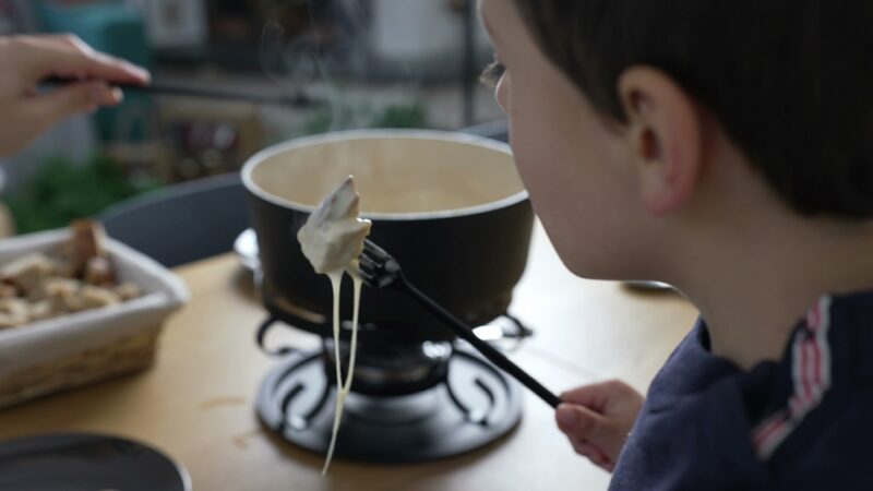 Person enjoying a traditional meal while learning about food safety and local eating habits